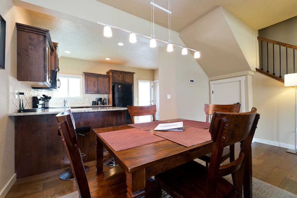 Dining area including a four person table and two bar stools