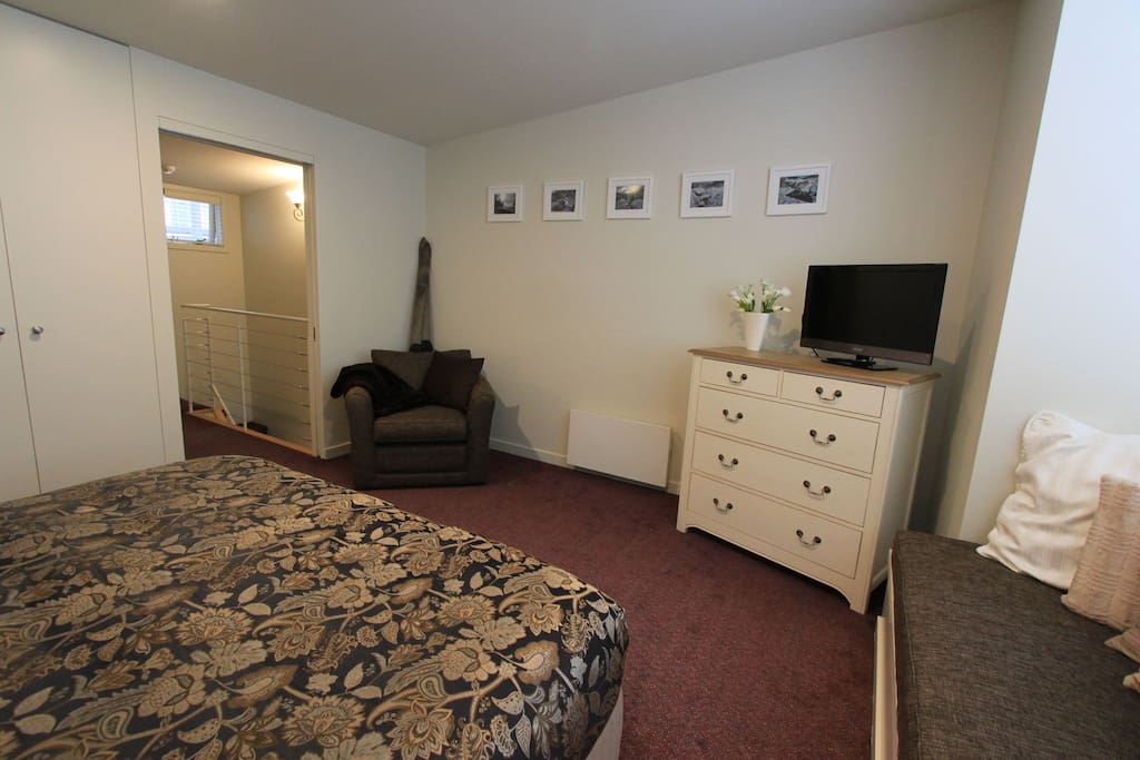 View of bedroom from the window seat back towards the stairs and bathroom.