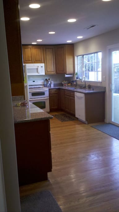 Updated modern kitchen with door to private yard. Have breakfast on patio.