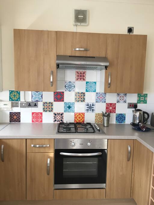 Fully equipped kitchen with gas hob, electric oven, microwave and dishwasher