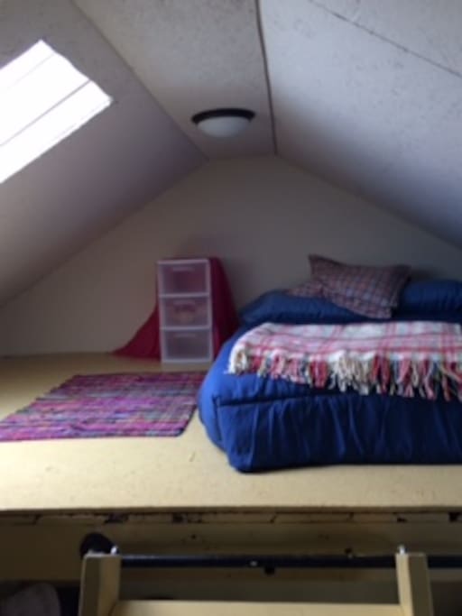 Queen size bed in loft.
