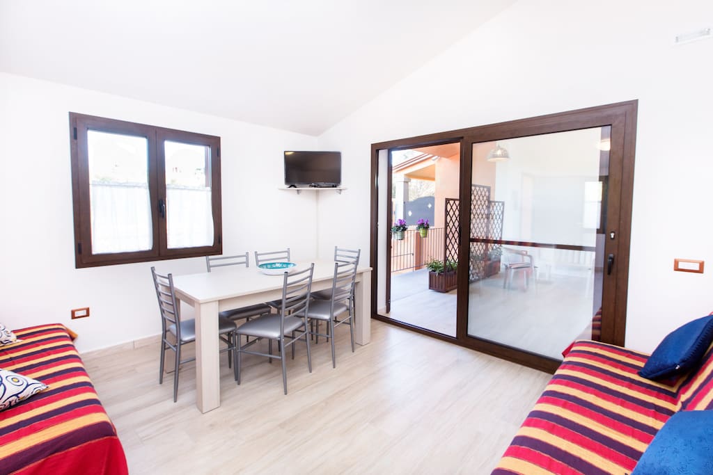 Floor 0 - the living area with terrace & dining table (inside and outside), Tv and 2 double bed sofa