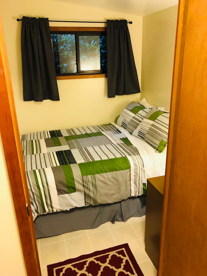 Bedroom with Double-size bed and three-drawer dresser.