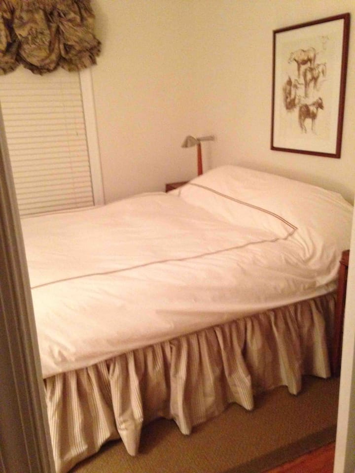 Beige & Tan Bedroom with full Bath across hall. Closet, desk, & dresser in space.