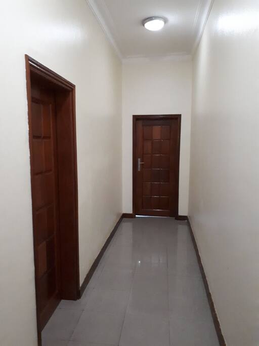 Spacious well lit corridor adjoining the living room to the bedrooms