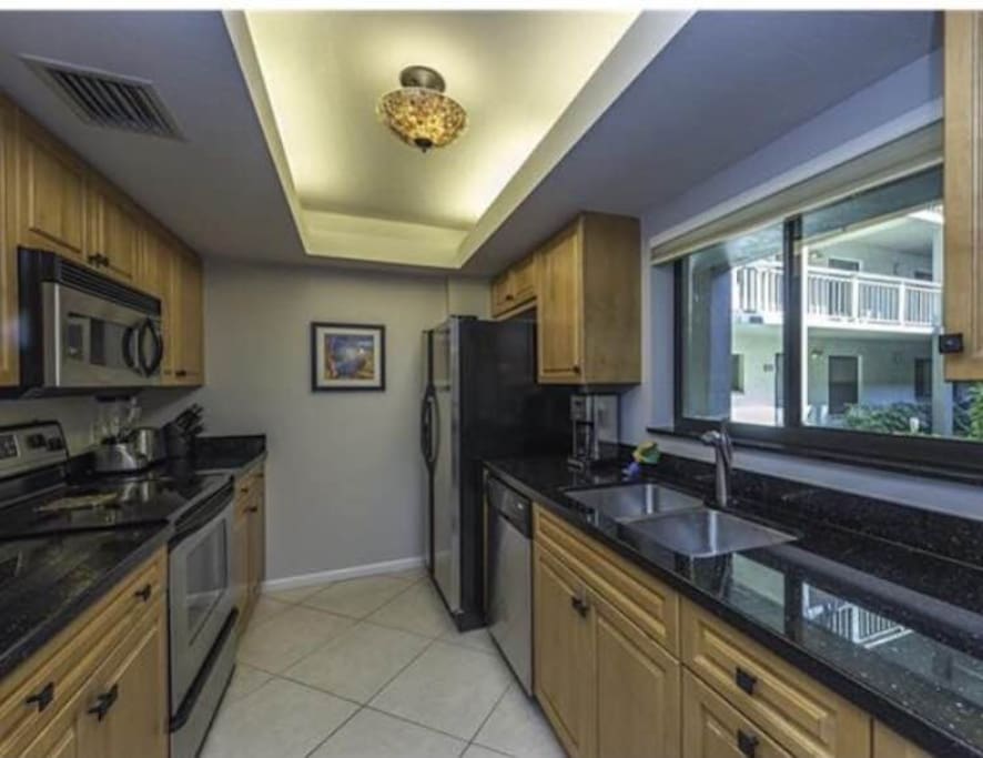 Granite counters, stainless appliances, and stocked with accessories