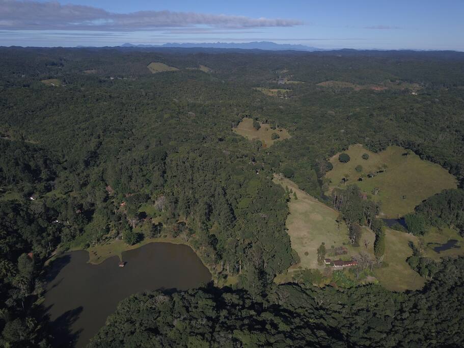 View of the area Mata Atlantica. Mountains at a distance is Area de Protecao Ambiental Ccaneia-Iquape, Peruibe. On the Horizon is the Ocean (darker blue)