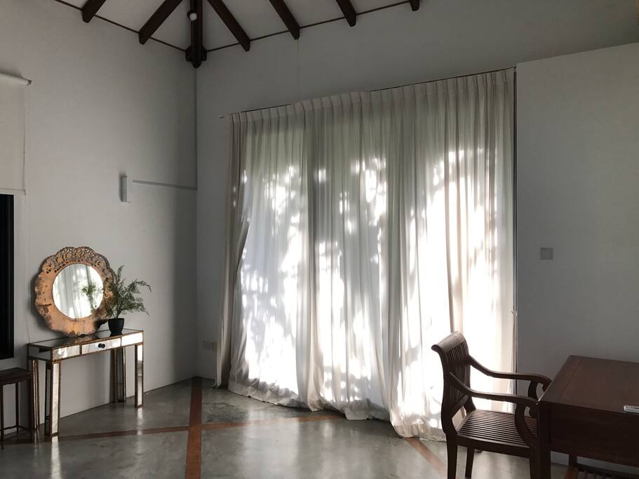 Sun filled guest room wih balcony