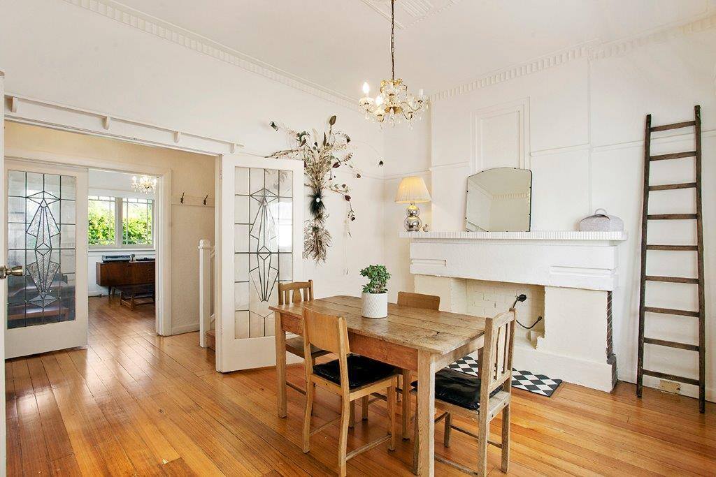 Open plan dining room and kitchen with windows out to courtyard