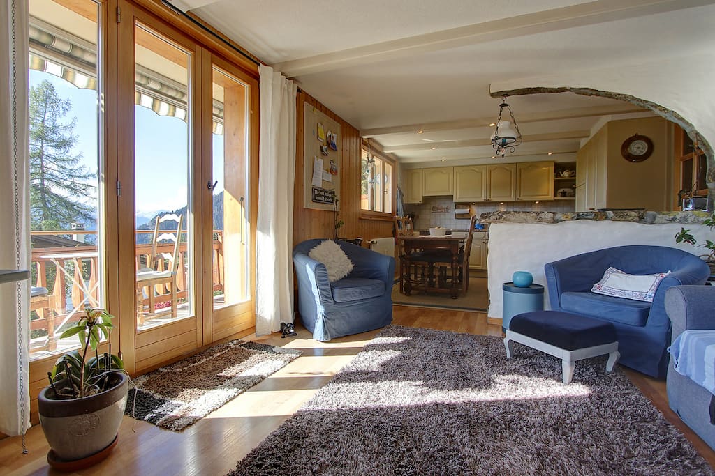 Lounge and kitchen, showing access door to large L shaped balcony.
