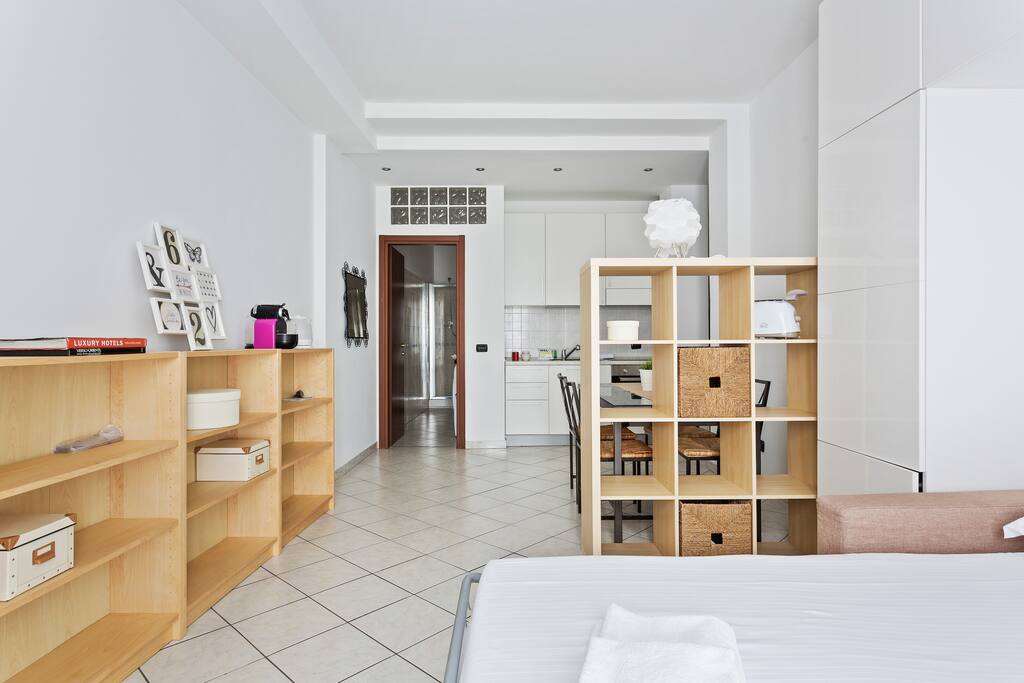 View from the bed: in front of you the equipped kitchen