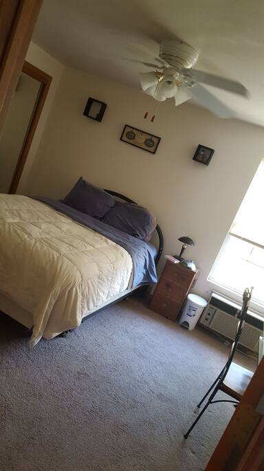 Queen size plush memory foam topped mattress. Great natural lighting. bedroom also includes some closet space w/hangers, and work desk.