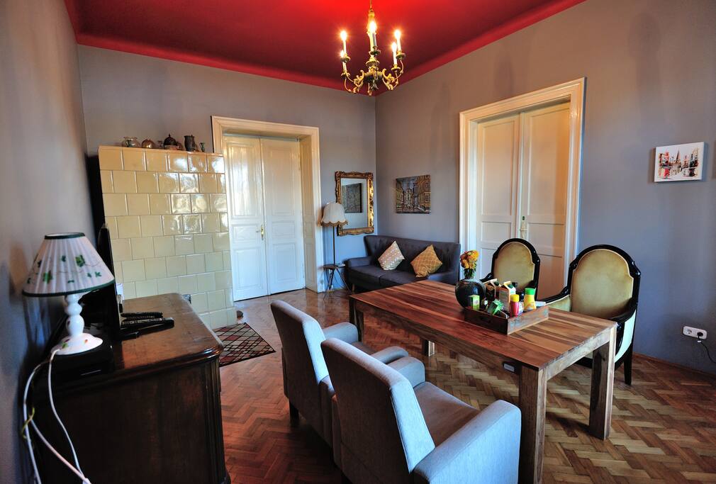 The living room showcases an eclectic mix of modern and antique furniture