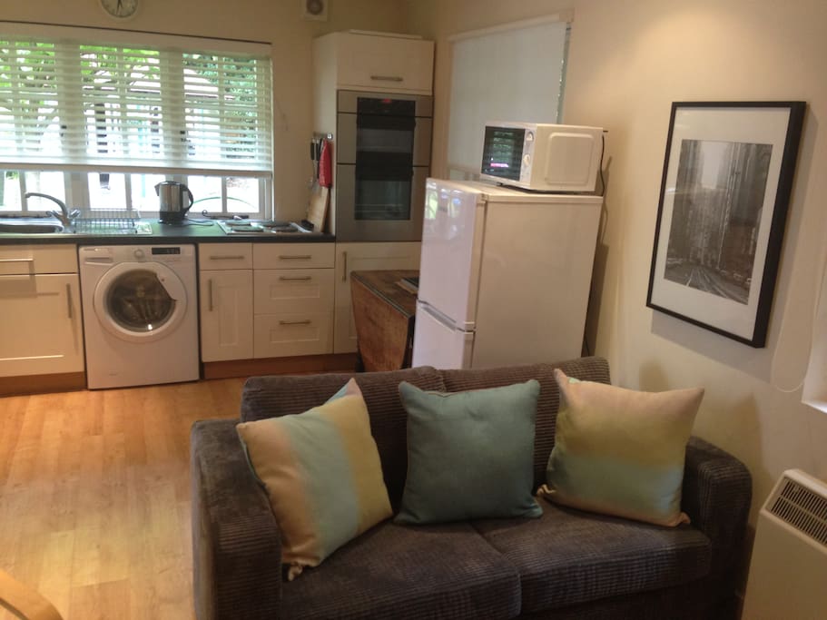 Washer/dryer, double oven, fridge freezer and microwave oven.