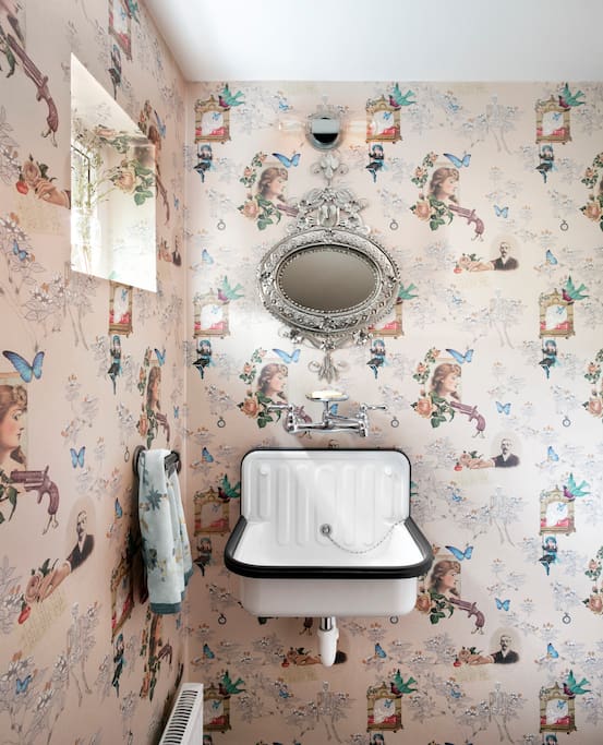 Powder room with surrealist wallpaper