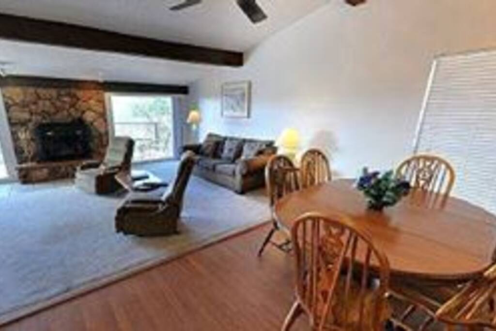 Inside condo. Living room and diner, completely furnished and equipped with a fireplace and a bar.