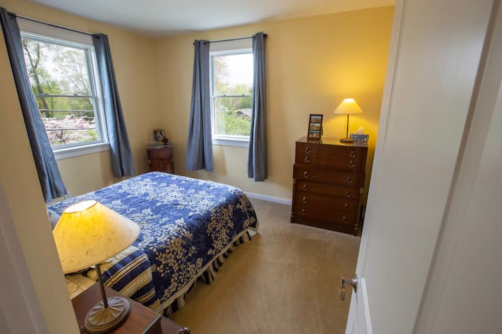 青いクイーンルームは、快適なベッドと十分なクローゼットスペースを備えた朝の光を提供しています。 各ベッドルームには扇風機もあります。 