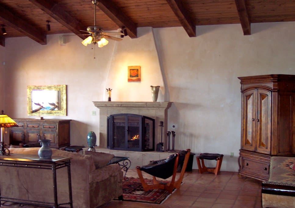 The living room features a large wood-burning fireplace