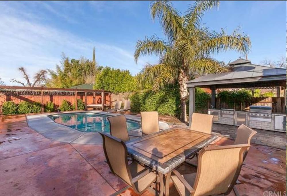 pool with outdoor kitchen.