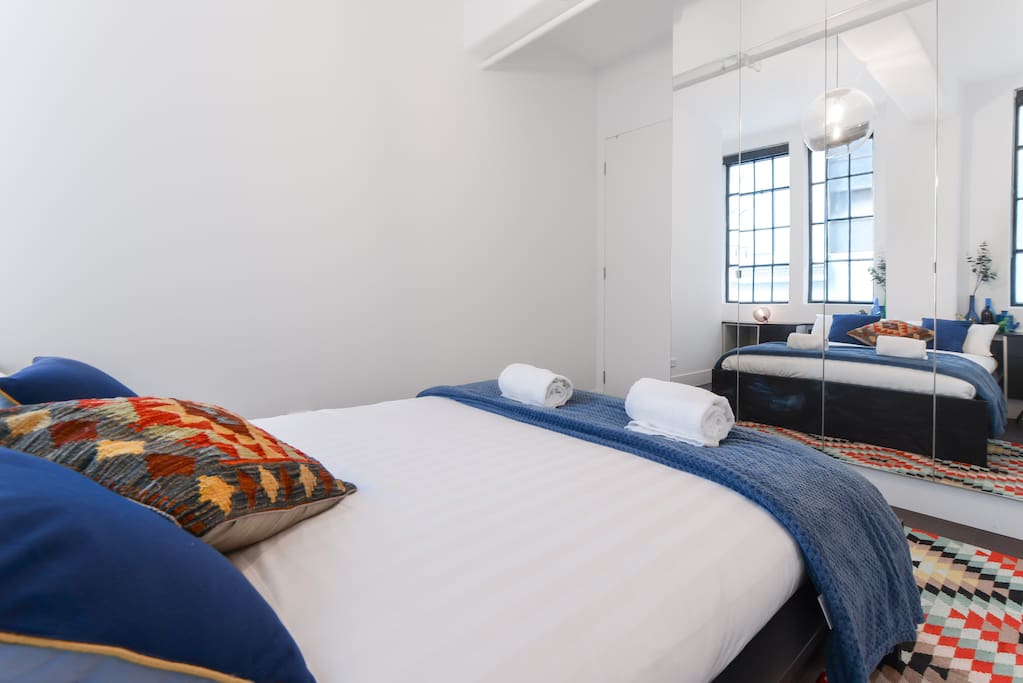 A queen size bed topped with high quality linens for a sound sleep