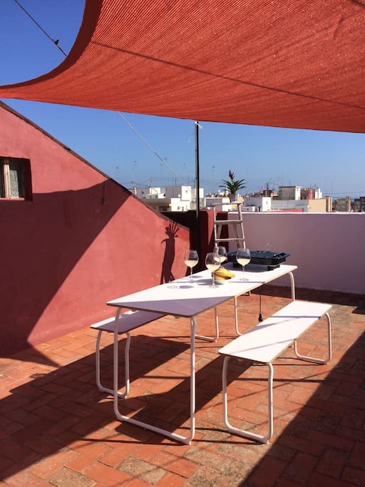 Communitarian terrace just one floor above the living room, with private furniture, barbecue and shadow veils