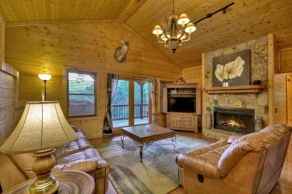 Beautiful leather couches make this living room by the fireplace quite cozy!