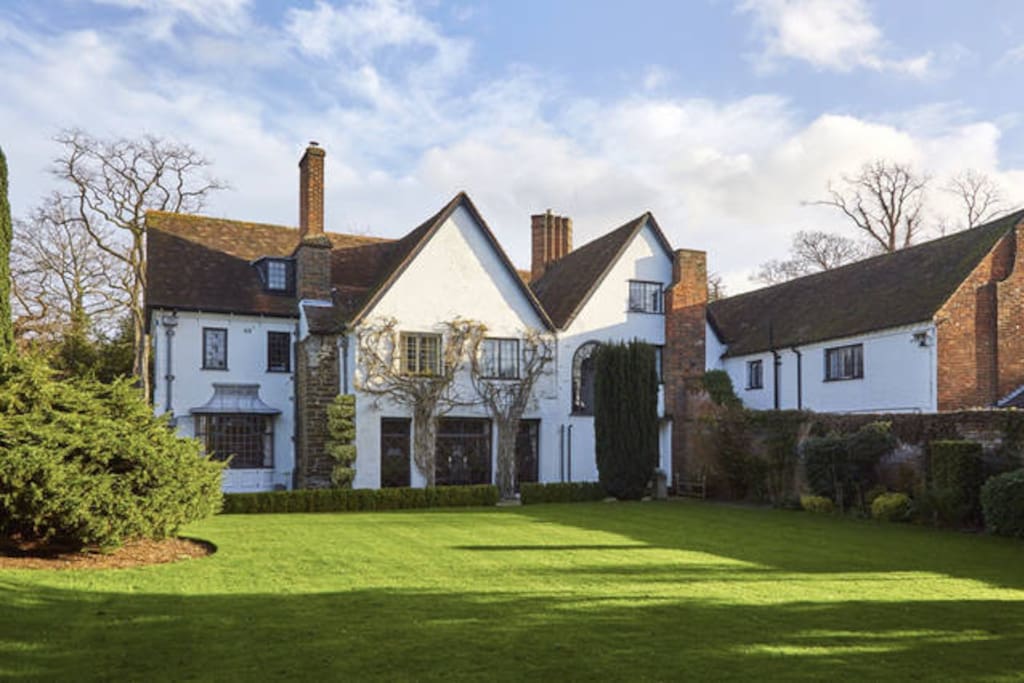 The West front of Harlington Manor. In Spring the wisteria is a perfumed riot of colour. The Garden Bedroom's two windows are those surrounded by the wisteria.