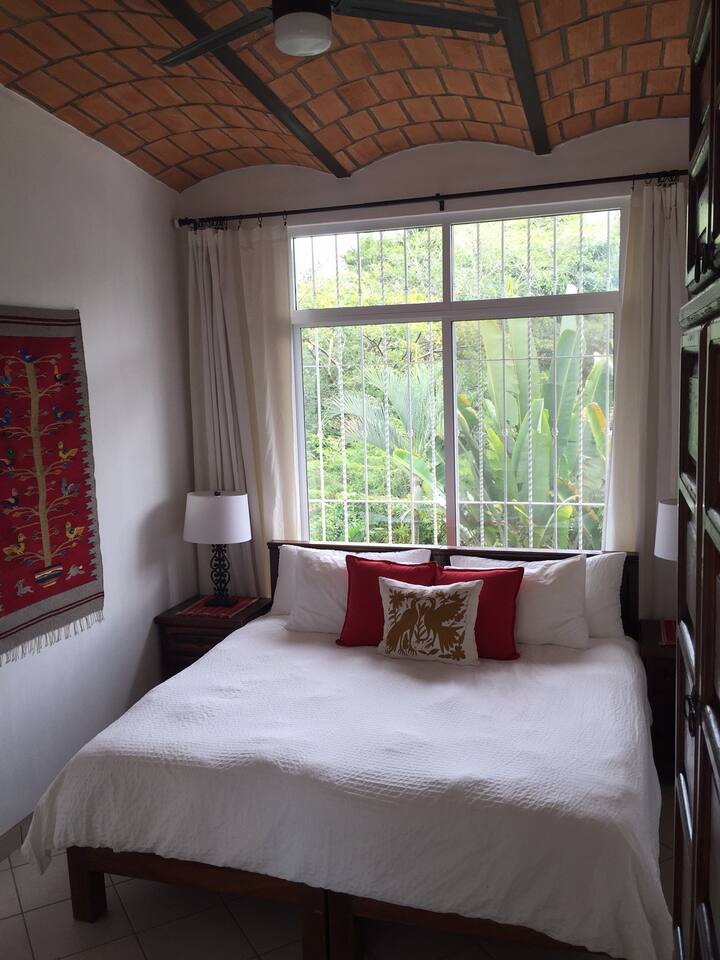 Upper bedroom with king bed overlooks back garden for privacy. 