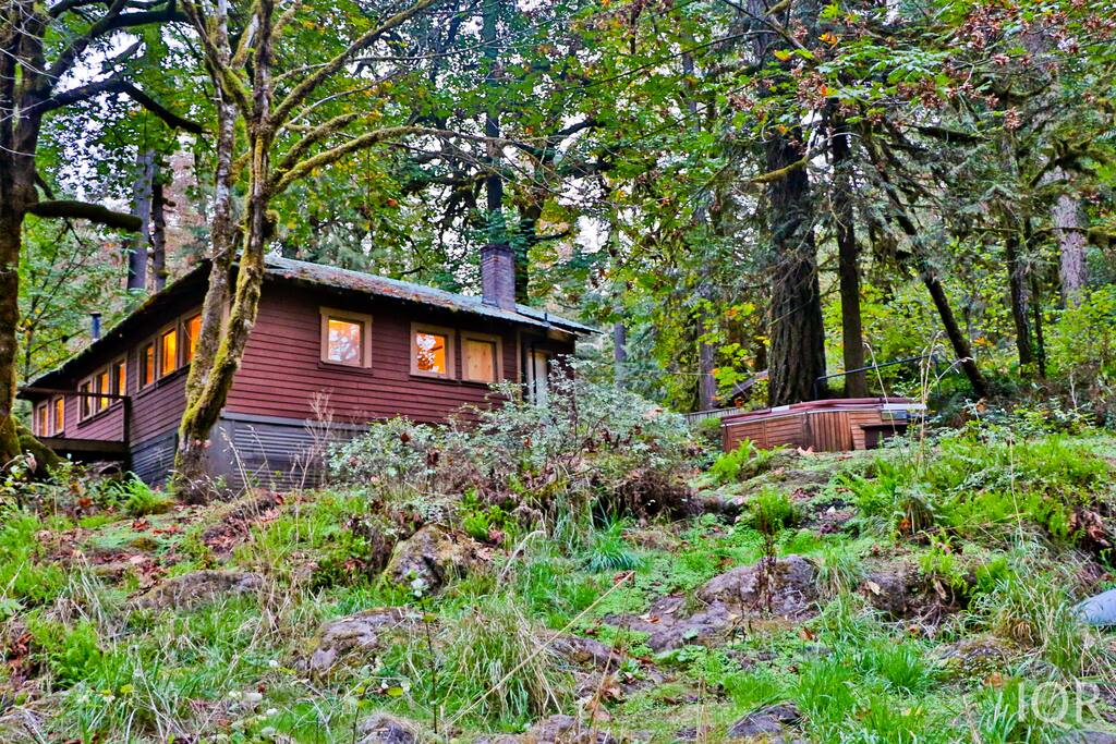 View of cabin and hot tub from the river.