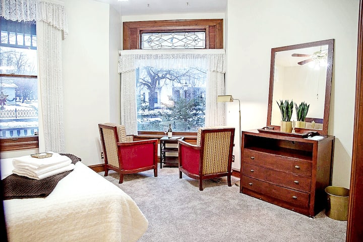  Master King bedroom with sitting area overlooking the historic Alexander Ramsey Home.