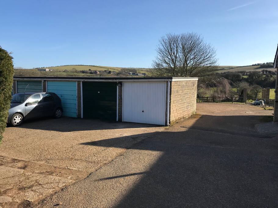 Our parking space is in front of the white garage door.