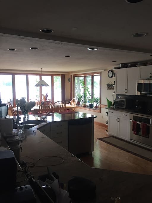 Kitchen with all stainless steel appliances and granite counter.
