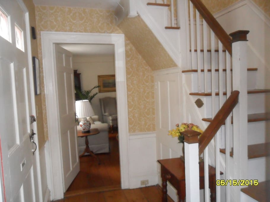 Front hall and staircase between living and dining rooms