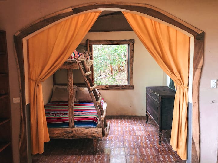 Spacious bunk room with bottom double bed and dresser 
