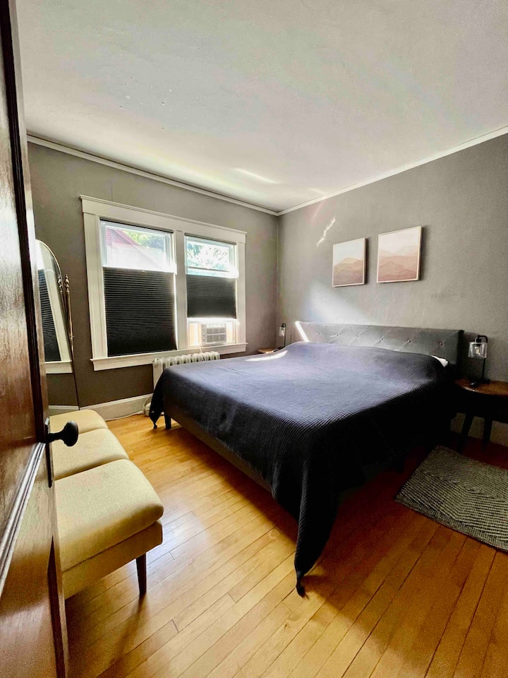 First floor king bed. Room is furnished with side tables, lamps with USB plugin,  bench for placing luggage or sitting, and closet.