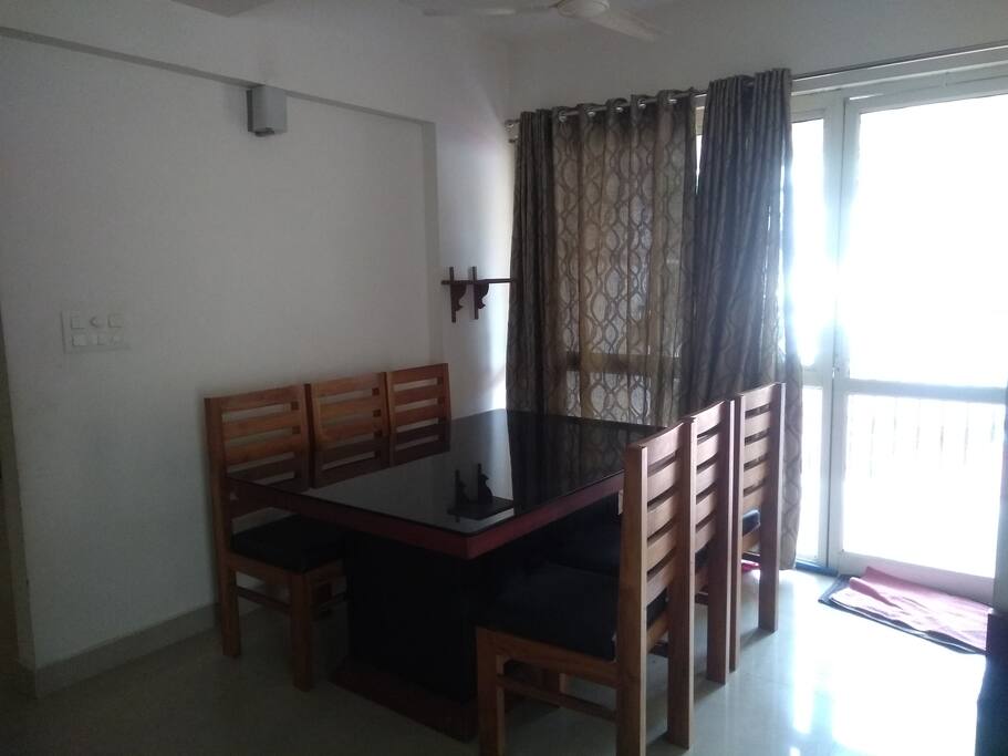 dining table with 6 chairs. you can see the balcony too