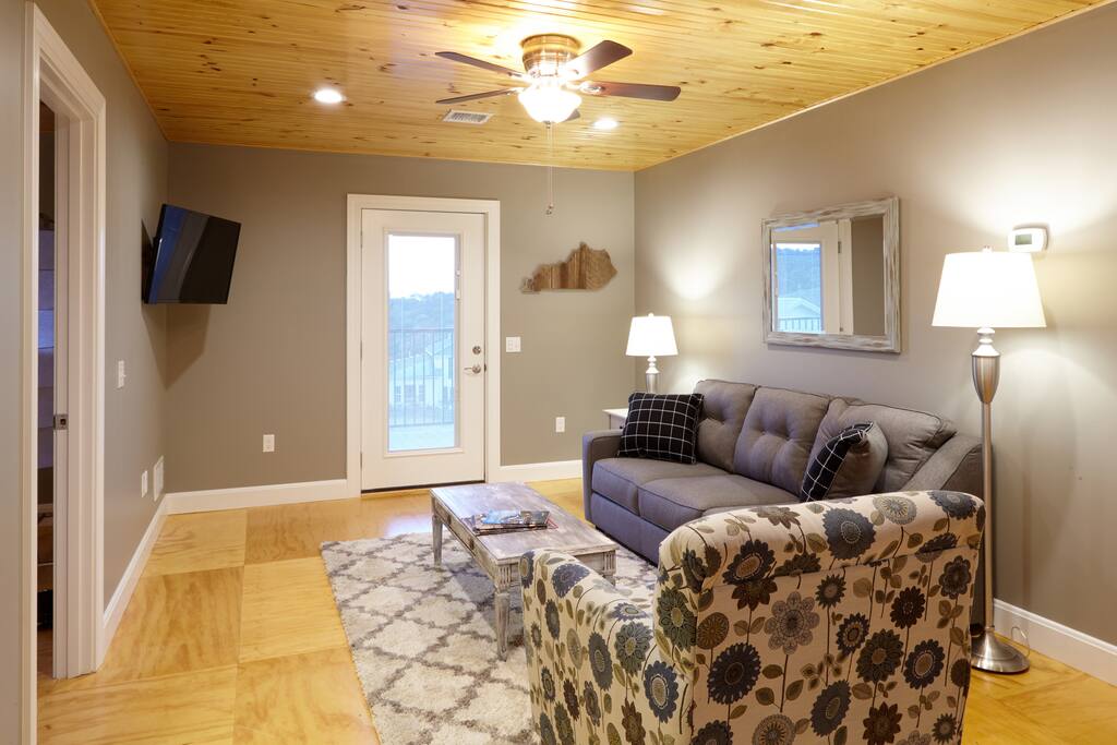 Living area as you walk in the door. Door to expansive outdoor deck overlooking the farm.