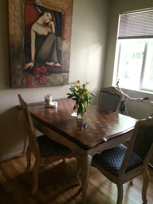 Close up of dining table, has a fourth chair that can be added