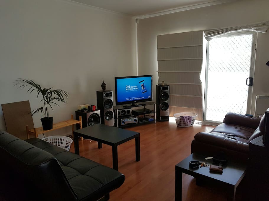 Small lounge room with top of the range couches and sound system