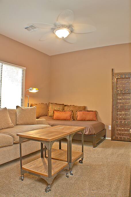 Den with single bed, couch and TV