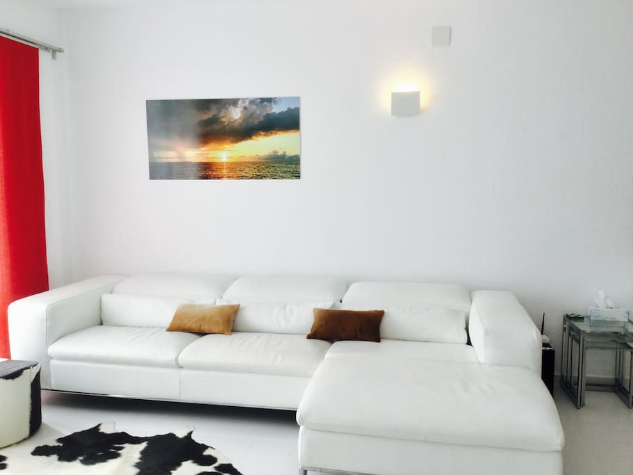 Bright, spacious lounge with stylish bespoke Italian leather sofa