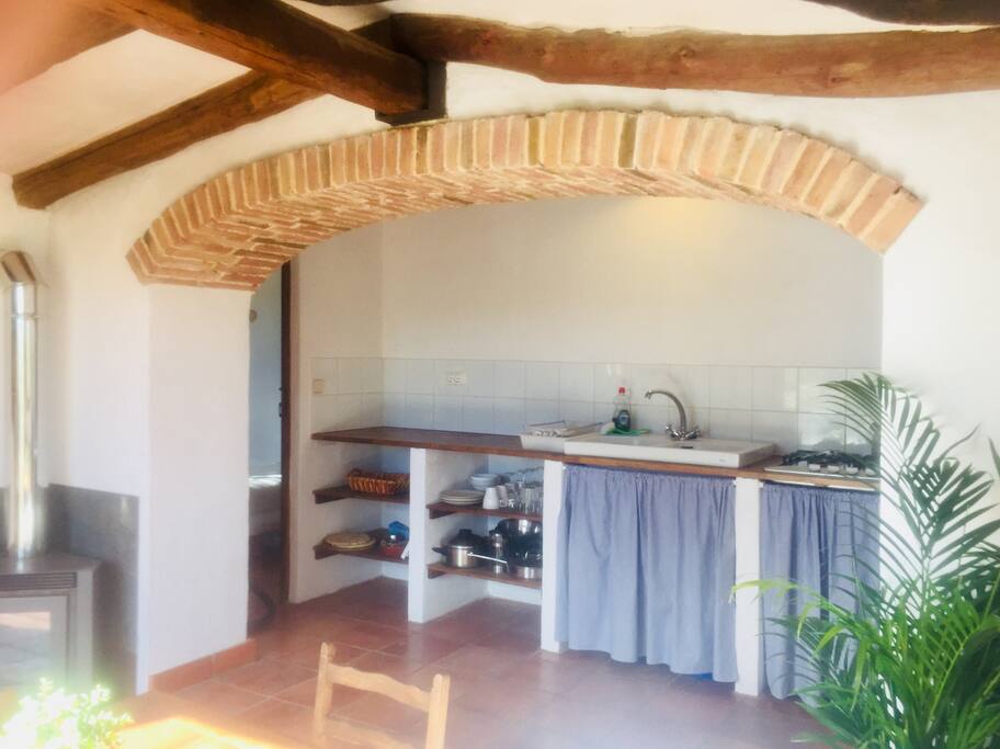 The open plan kitchen has sink, fridge, hob and all pots, pans, glasses etc.
