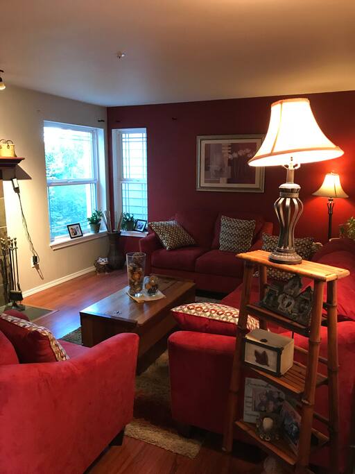 Living room attached to an open dining room and kitchen. For guests to use. Also attached to deck.