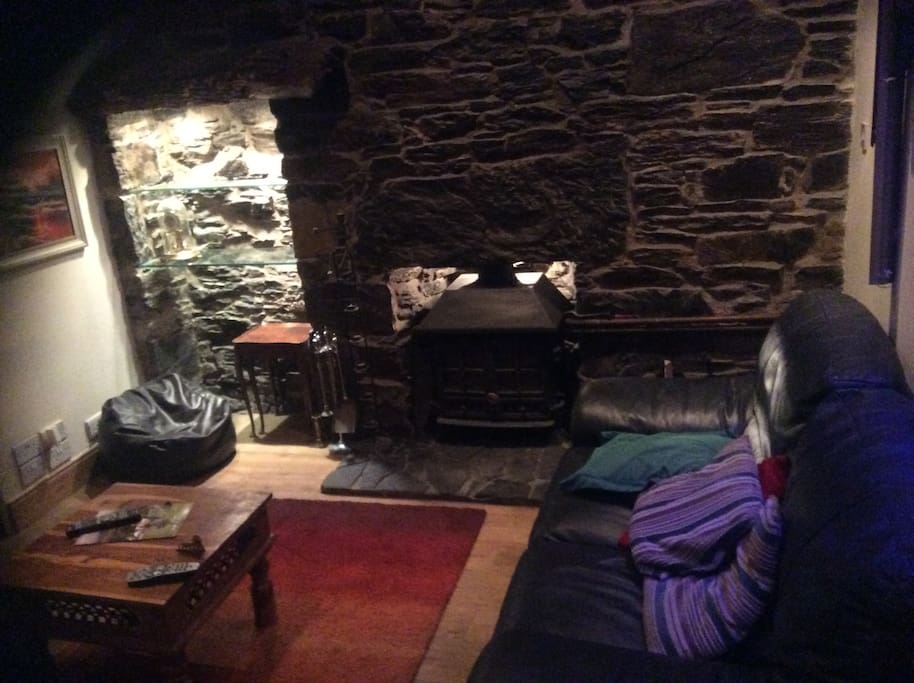 Lounge with multi fuel burner, two generous sofas with views to the hills beyond the village.