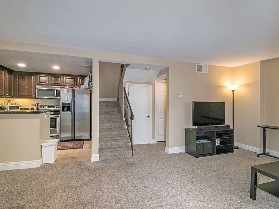 Living area looking into dining, kitchen, & stairway