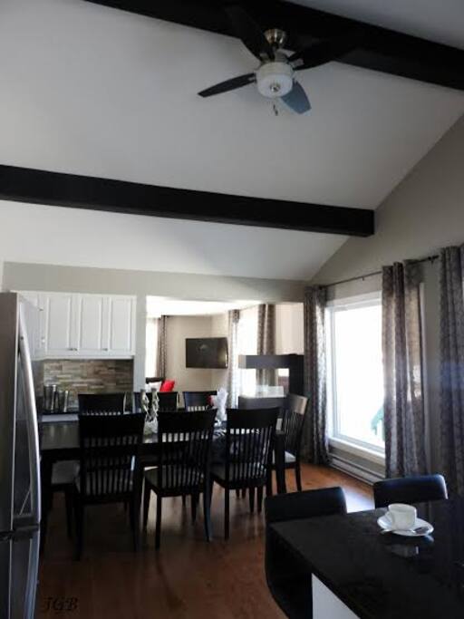 Dining room leading into the living room - tons of natural light throughout the cottage.
