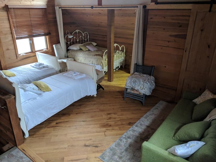 Sunset bedroom sleeps one to four people (one queen, two singles, & a sofa sleeper). Additional mini split system installed for microclimate control.