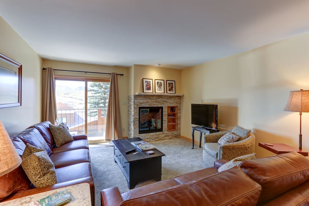 Living room with brand new leather couches, gas fireplace, etc.