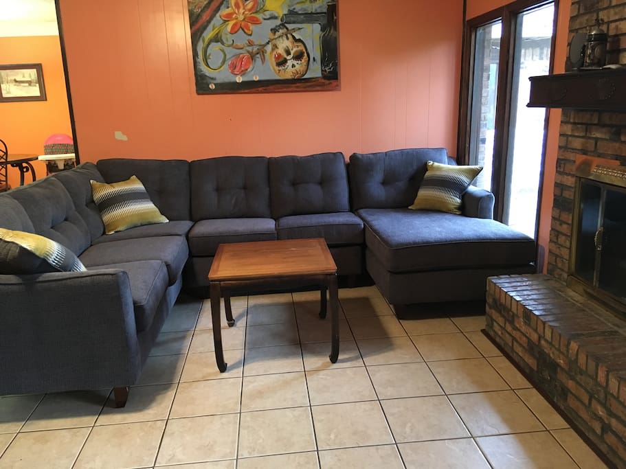 Common living room with brand new sectional provides plenty of room for guests. Wood burning fireplace available for those cold rainy days.