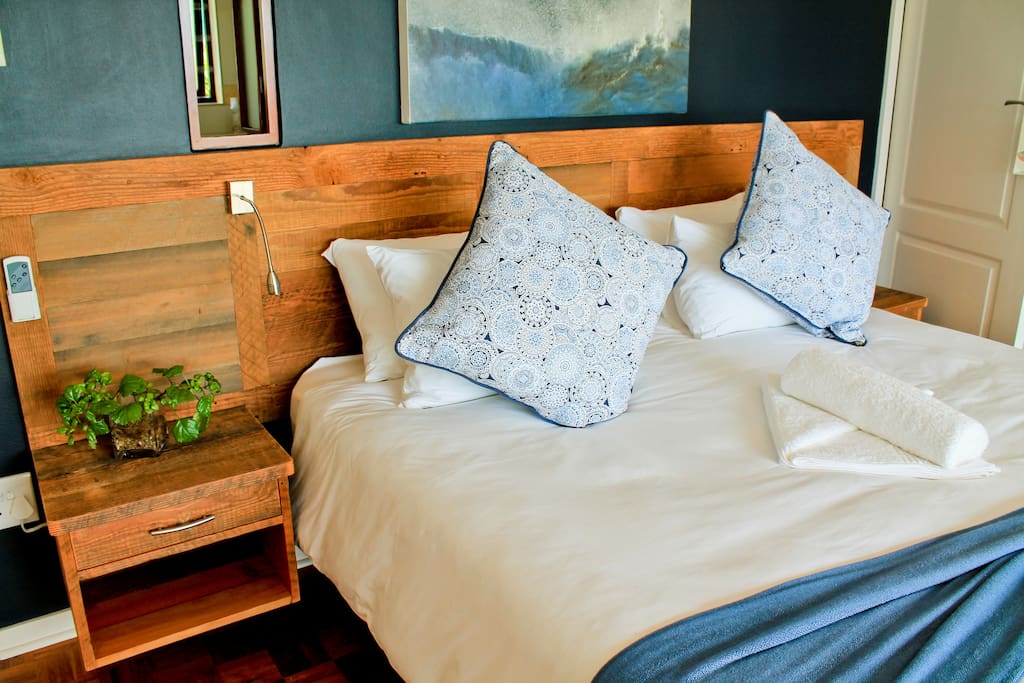 Stunning en-suite bedroom with king-size bed, veranda access and ocean view